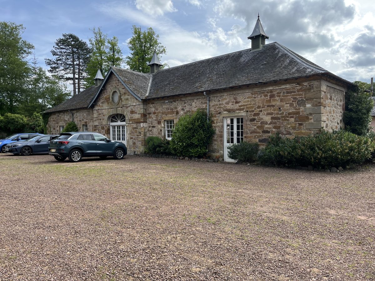 Colstoun House wedding venue exterior — historic stone stable block with cupolas and gravel courtyard, East Lothian, Scotland
