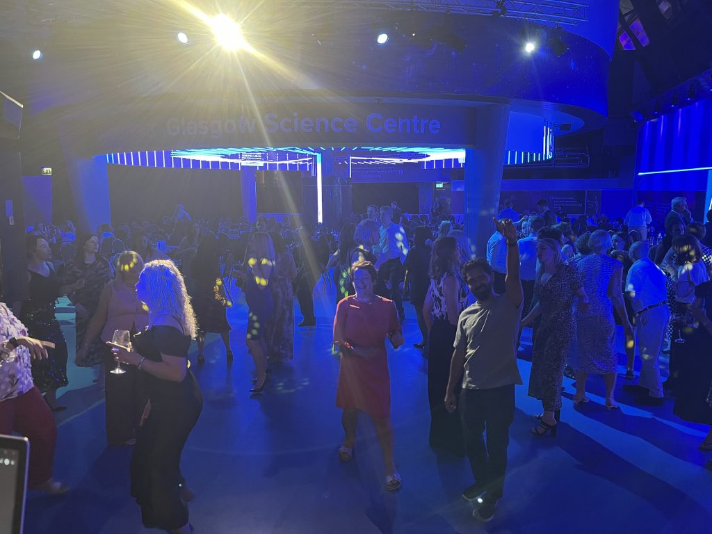 Corporate ceilidh dancefloor in full swing at Glasgow Science Centre — guests dancing