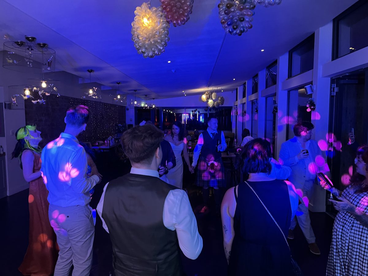Evening party under blue lighting at Restoration Yard, Dalkeith Country Park