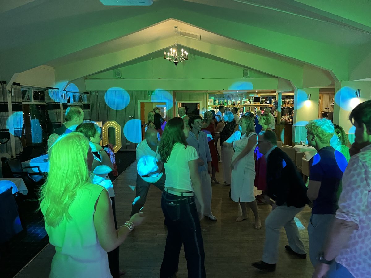 Guests dancing under colourful lighting late in the evening at Craigie Hill Golf Club
